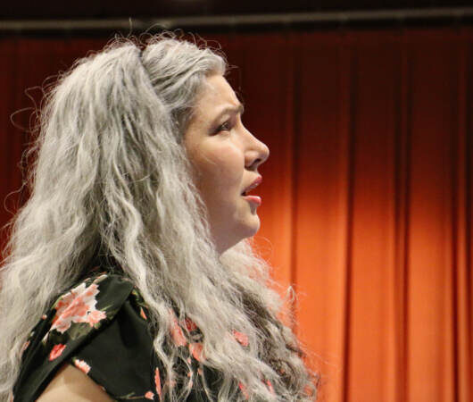Maren Montalbano in profile, singing.